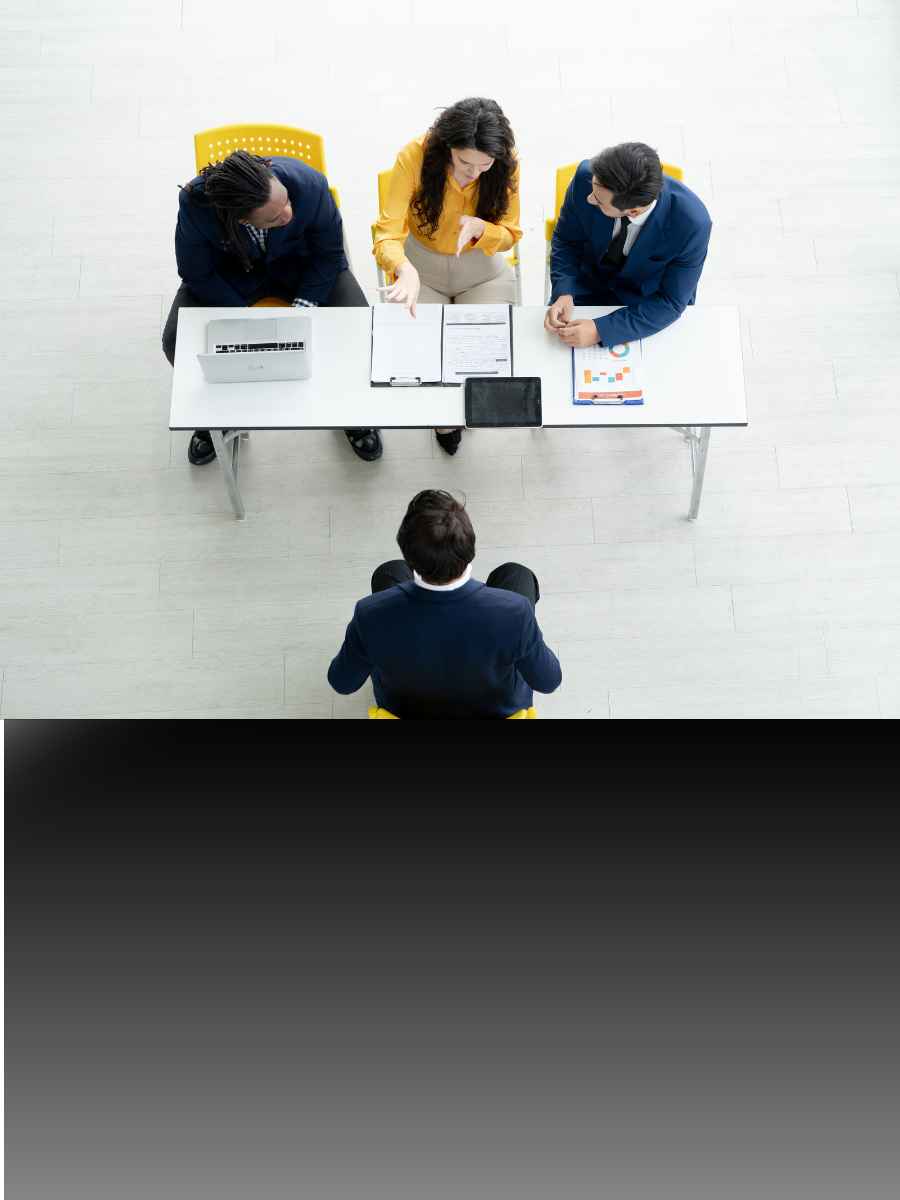 Group of professionals collaborating with laptops in an office
